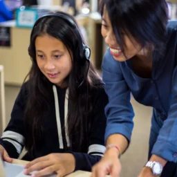 teacher helping girl.